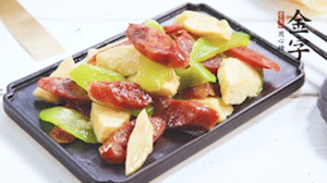 熱油下鍋，依次下金字香腸、萵筍、冬筍，均勻翻炒。