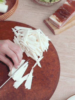 茭白切細絲，鹽水中浸泡防止氧化。